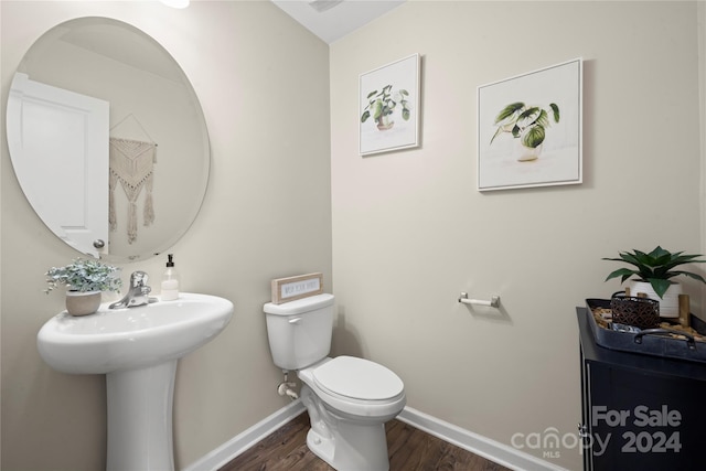 bathroom featuring toilet and hardwood / wood-style flooring