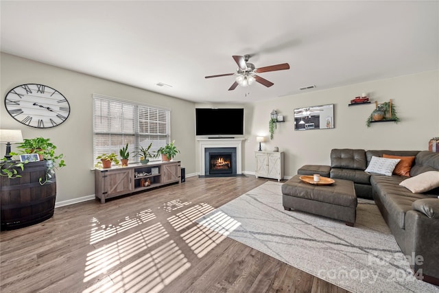 living room featuring hardwood / wood-style flooring and ceiling fan