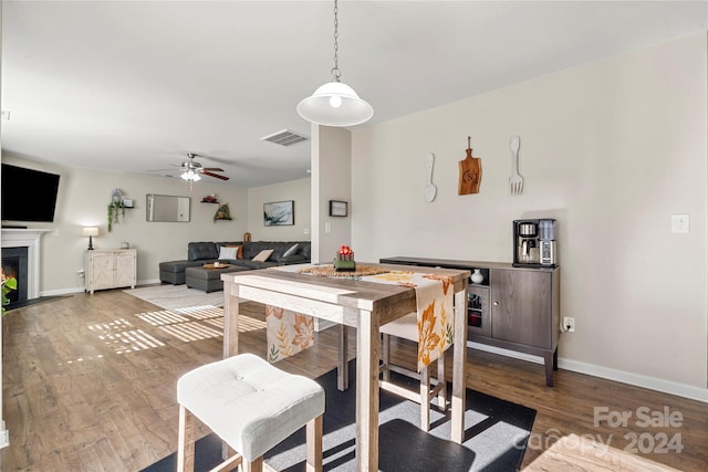 dining area featuring wood-type flooring and ceiling fan