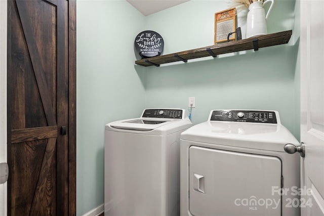 washroom featuring washer and clothes dryer