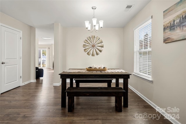 dining area with a chandelier and dark wood-type flooring