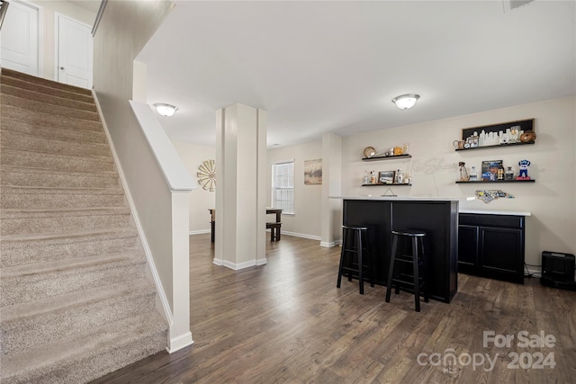 bar featuring dark wood-type flooring