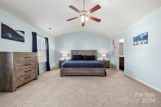 bedroom featuring ensuite bath, ceiling fan, light carpet, and vaulted ceiling