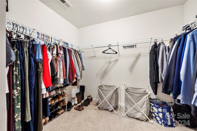 walk in closet with carpet floors