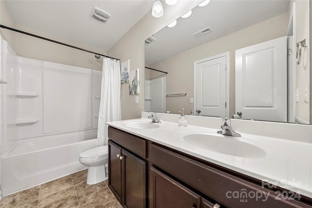 full bathroom featuring shower / tub combo, vanity, and toilet