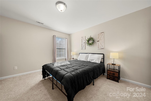 bedroom with light colored carpet