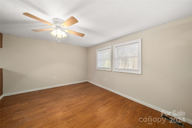 spare room with ceiling fan and hardwood / wood-style flooring