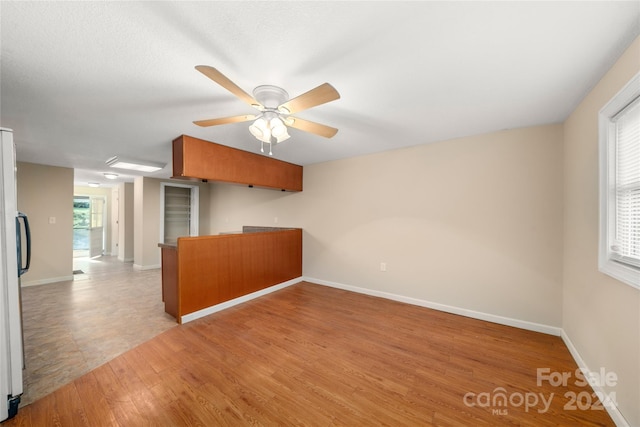 unfurnished room with ceiling fan and light hardwood / wood-style flooring