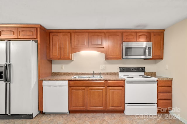 kitchen with sink and white appliances