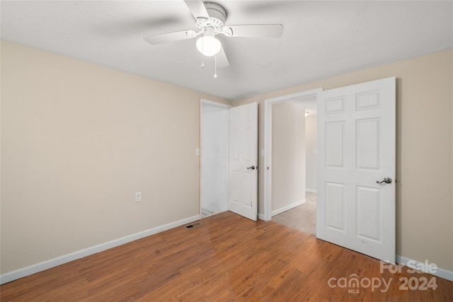 unfurnished bedroom featuring ceiling fan and wood-type flooring