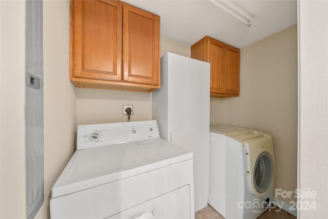 laundry area with cabinets and separate washer and dryer