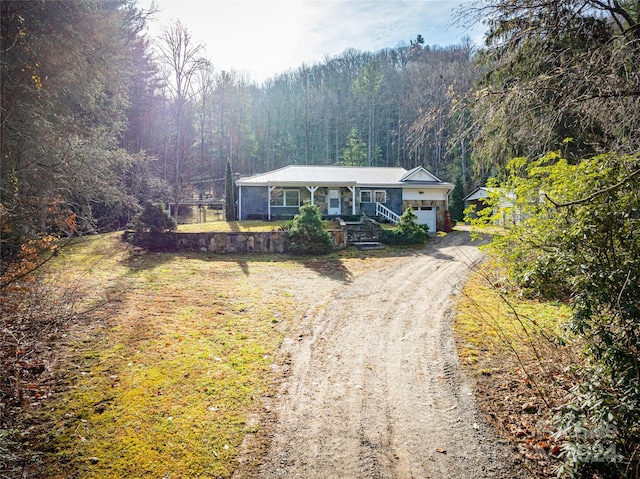 single story home with a porch and a garage