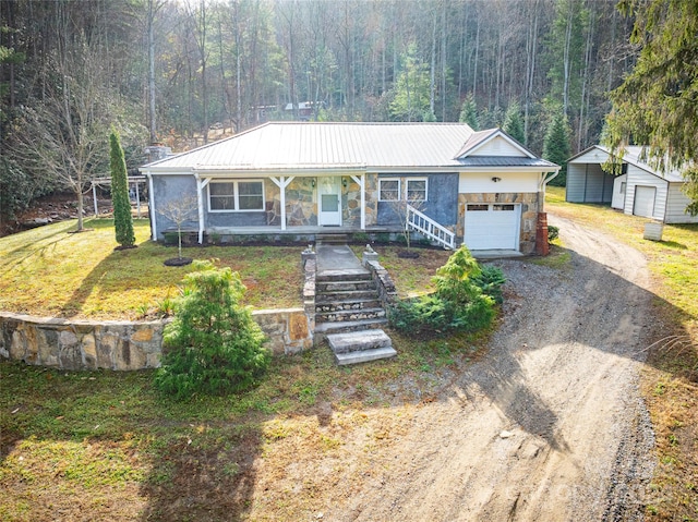 ranch-style house with a front yard, a porch, and a garage