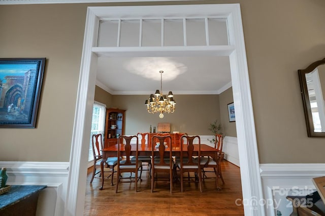 dining room featuring a wainscoted wall, ornamental molding, and plenty of natural light