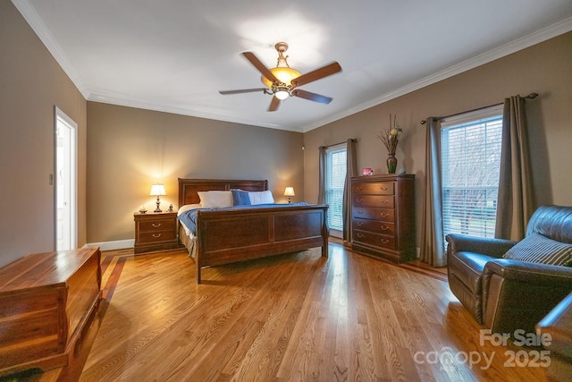 bedroom featuring baseboards, a ceiling fan, light wood-style flooring, and crown molding