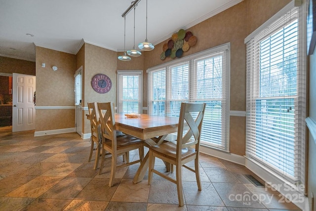 dining area with crown molding, wallpapered walls, visible vents, and baseboards