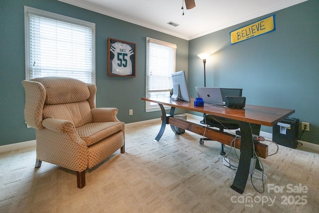 office area with light carpet, a ceiling fan, visible vents, baseboards, and ornamental molding