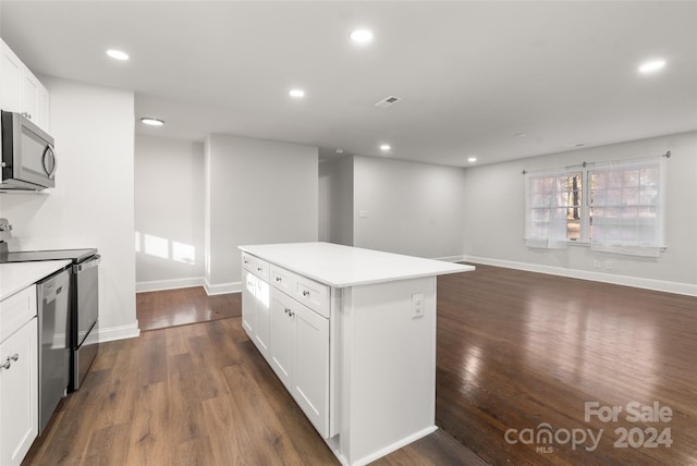 kitchen featuring white cabinets, a center island, dark wood-type flooring, and appliances with stainless steel finishes