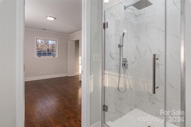 bathroom with hardwood / wood-style flooring, walk in shower, and ornamental molding