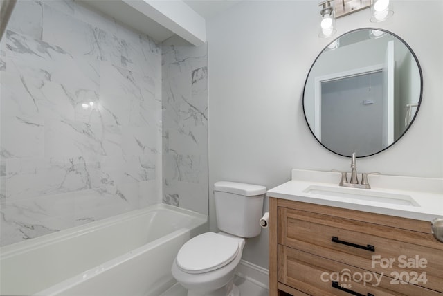 full bathroom featuring tiled shower / bath, vanity, and toilet