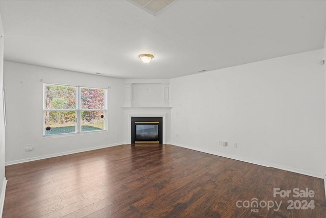 unfurnished living room with dark hardwood / wood-style flooring