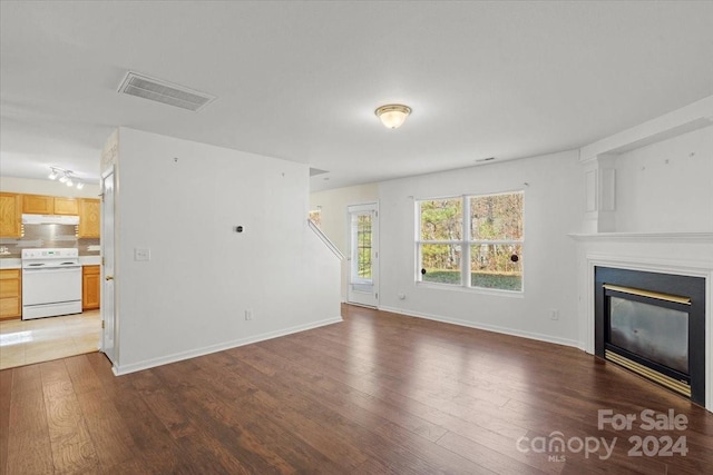 unfurnished living room featuring dark wood-type flooring