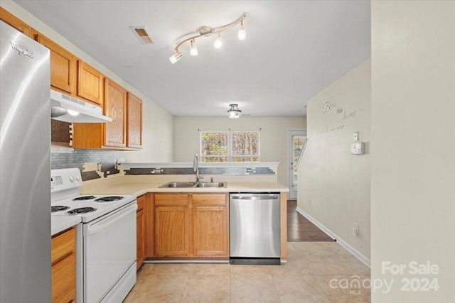 kitchen with decorative backsplash, light tile patterned floors, sink, and appliances with stainless steel finishes