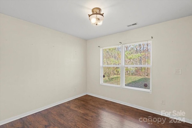 spare room featuring dark hardwood / wood-style flooring