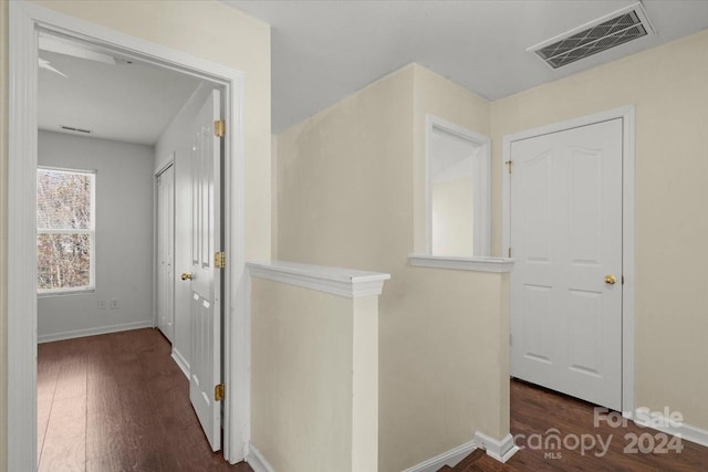 hallway with dark hardwood / wood-style flooring