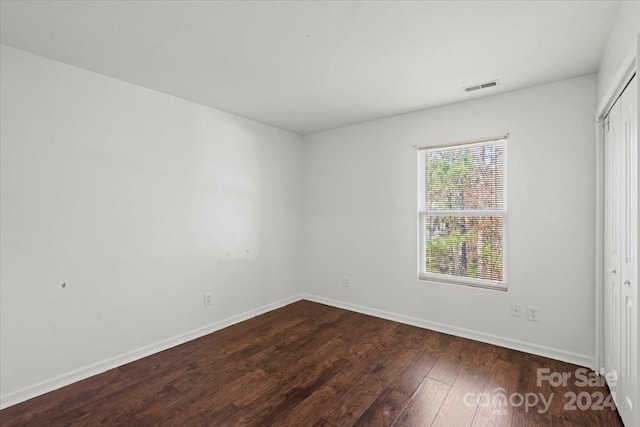 unfurnished room featuring dark hardwood / wood-style flooring