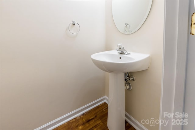 bathroom featuring baseboards and wood finished floors