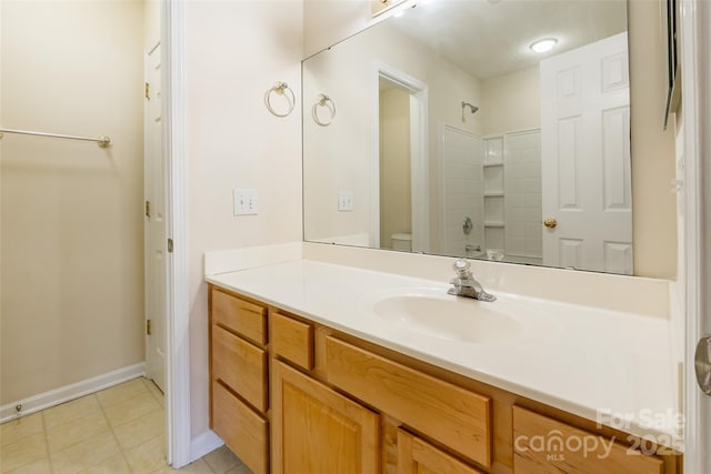 full bath with toilet, baseboards, and vanity