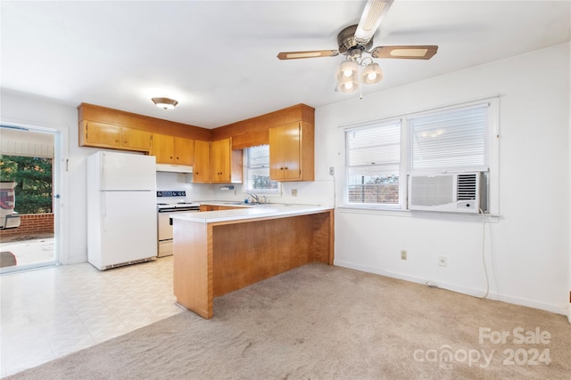 kitchen with light colored carpet, white appliances, and kitchen peninsula