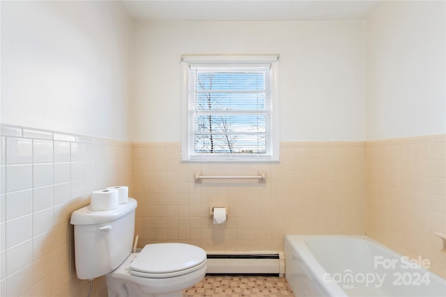 bathroom with a bathing tub, toilet, baseboard heating, and tile walls