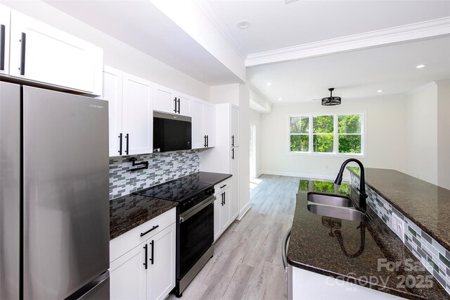 6534 Providence Rd, Charlotte, NC 28226 - kitchen with a sink, freestanding refrigerator, range with electric cooktop, white cabinetry, and decorative backsplash