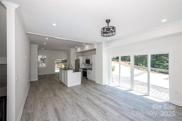 6534 Providence Rd, Charlotte, NC 28226 - unfurnished living room with crown molding, baseboards, light wood-type flooring, and recessed lighting