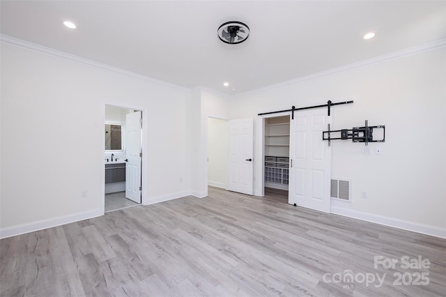 6534 Providence Rd, Charlotte, NC 28226 - unfurnished bedroom with a barn door, baseboards, visible vents, crown molding, and wood finished floors