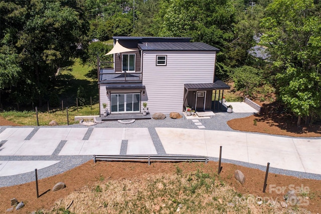 6534 Providence Rd, Charlotte, NC 28226 - back of house featuring metal roof and a balcony