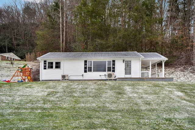 manufactured / mobile home featuring a front lawn, metal roof, and a playground