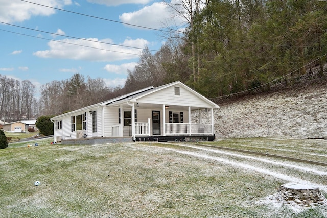 view of front facade with a front yard and a porch