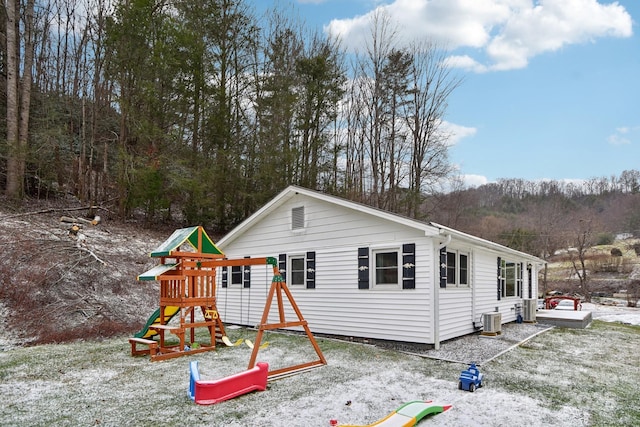 exterior space with a playground and cooling unit