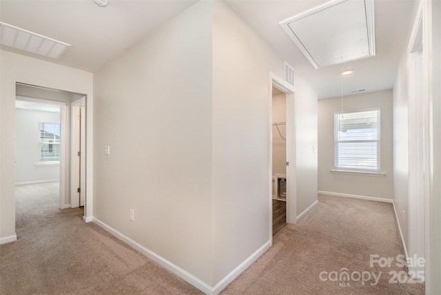 hallway featuring light carpet