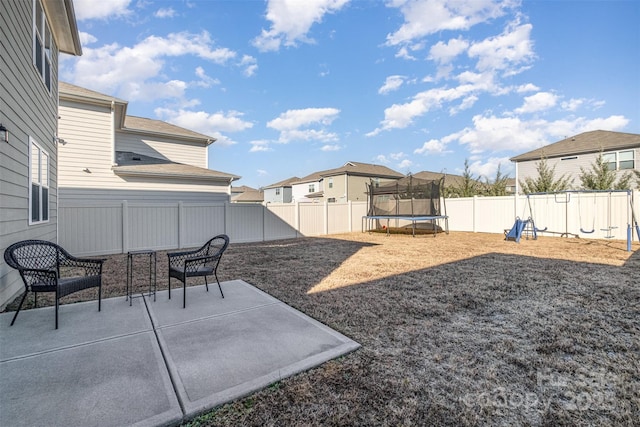 view of yard featuring a patio and a trampoline