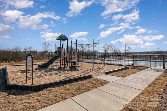 view of jungle gym featuring a community pool