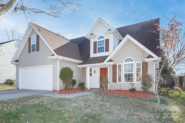 view of front of property with a garage and a front lawn