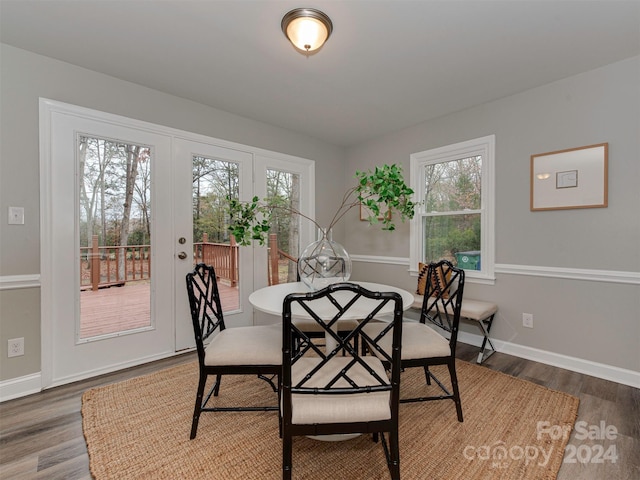 dining space featuring dark hardwood / wood-style floors and a healthy amount of sunlight