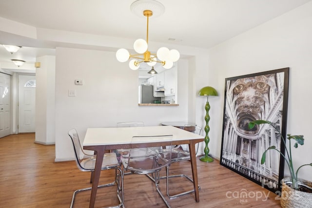 5300 Fair Wind Ln, Charlotte, NC 28212 - dining room featuring baseboards, visible vents, a chandelier, and light wood-style floors