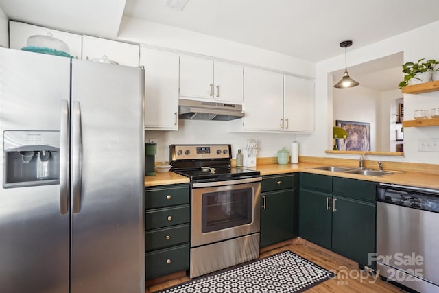 5300 Fair Wind Ln, Charlotte, NC 28212 - kitchen featuring light countertops, a sink, appliances with stainless steel finishes, under cabinet range hood, and white cabinets