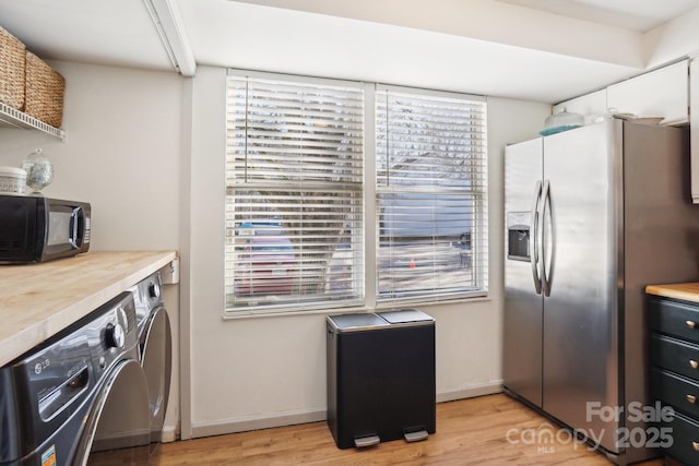 5300 Fair Wind Ln, Charlotte, NC 28212 - kitchen featuring light countertops, stainless steel fridge, separate washer and dryer, light wood finished floors, and black microwave