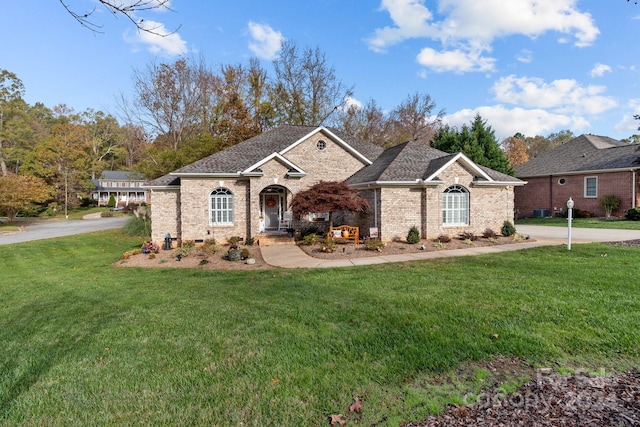 ranch-style home featuring a front yard